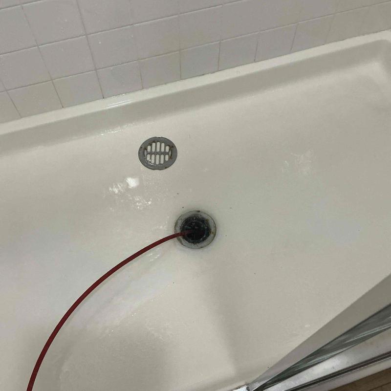 Shower drain snaking to clear hair blockage