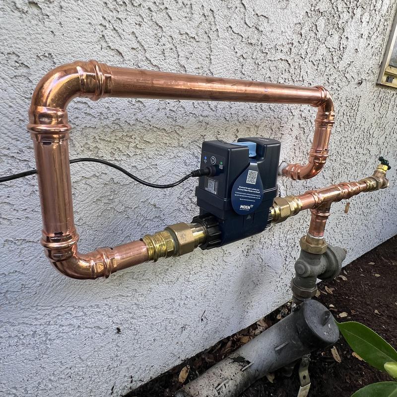 Flo by Moen water flow monitoring device with copper piping