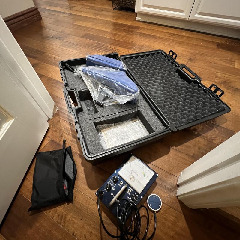 Slab leak detection equipment in foam case on floor