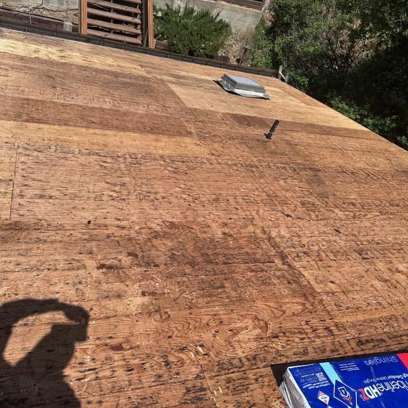 Plywood roof decking with skylight base and vent pipe