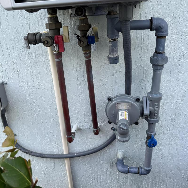 Tankless water heater gas regulator and piping setup