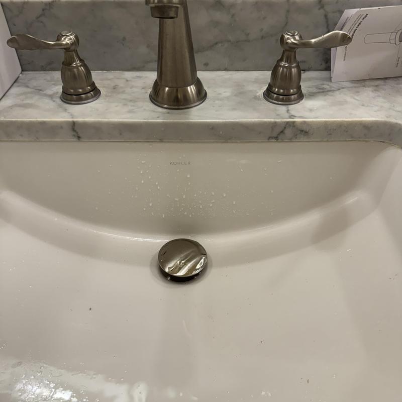 Bathroom sink pop-up drain assembly installed and tested