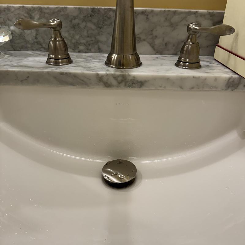 Pop-up sink drain assembly in master bathroom sink