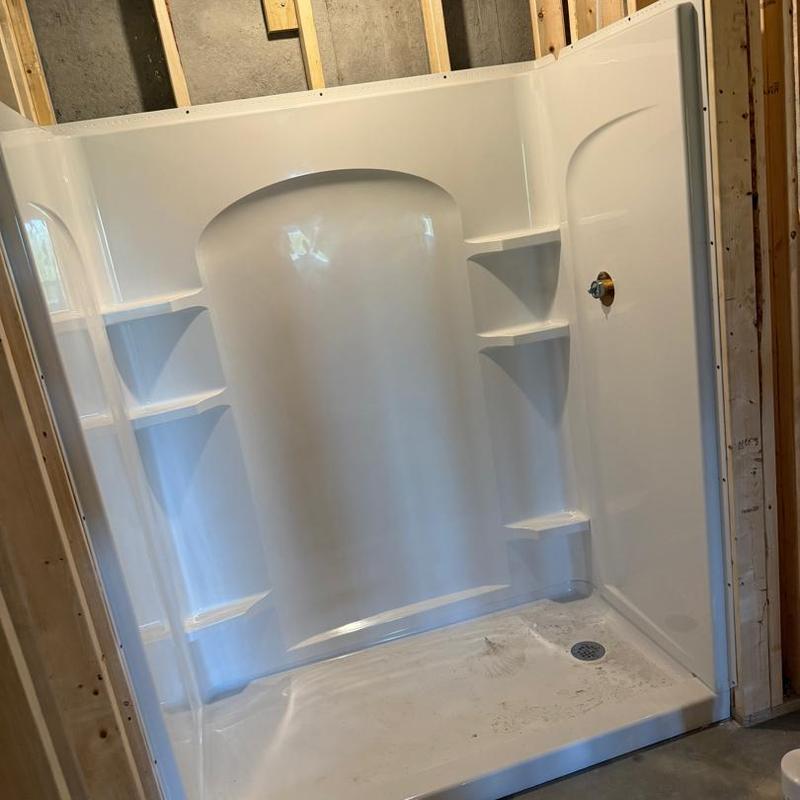 Shower stall installation with built-in shelving