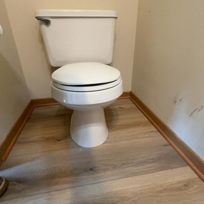 Toilet with new drain seal and shimming installation