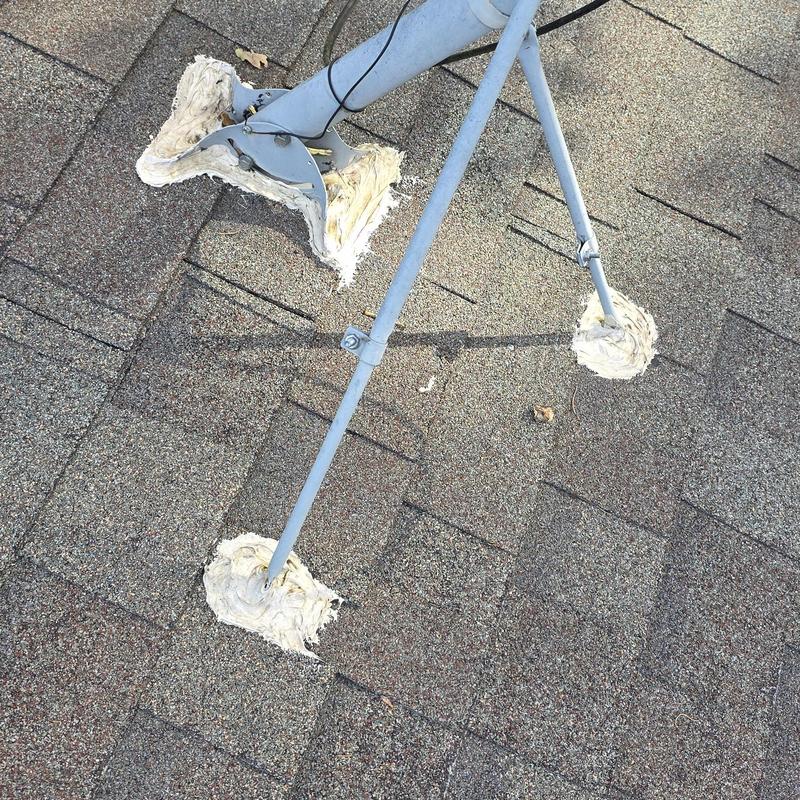 Satellite dish mounting sealed on shingle roof after hail damage
