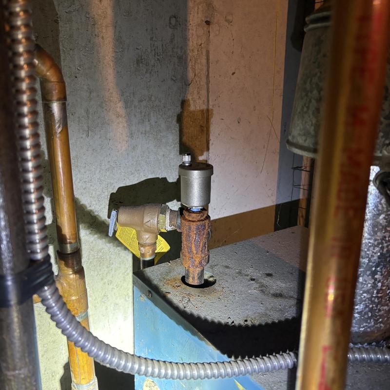 Rusty boiler Hubert valve with nearby copper piping