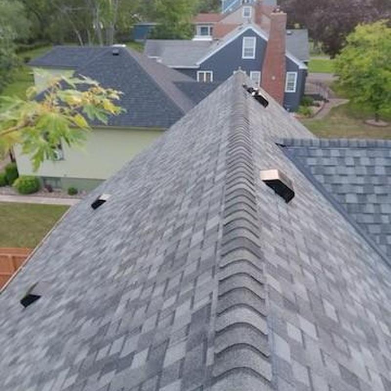 Asphalt shingle roof with ridge vents and new installation Asphalt shingle roof with ridge vents and new installation
