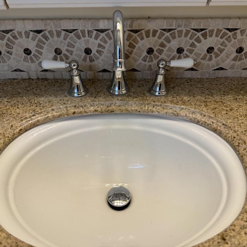 Wide spread bathroom faucet with granite countertop