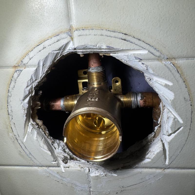 Tub shower valve plumbing with cut tile access hole
