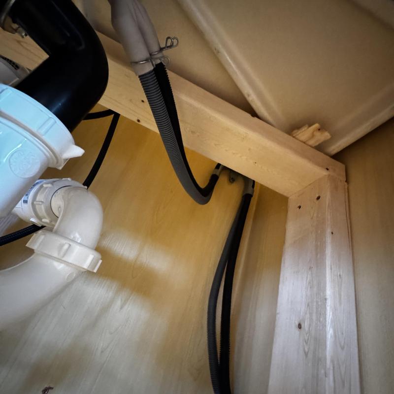 Dishwasher drain and water supply hoses installation under sink
