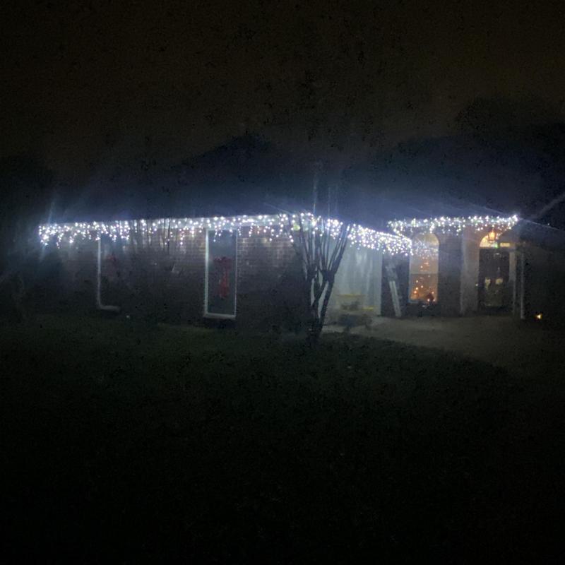 White string decorative lights on house eaves at night White string decorative lights on house eaves at night