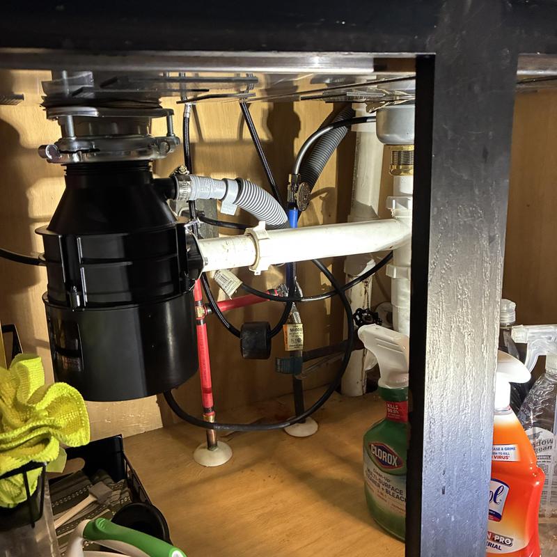 Garbage disposal and basket strainer installation under sink