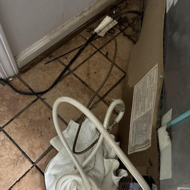 Ice maker water pipe capped with towel and tubing