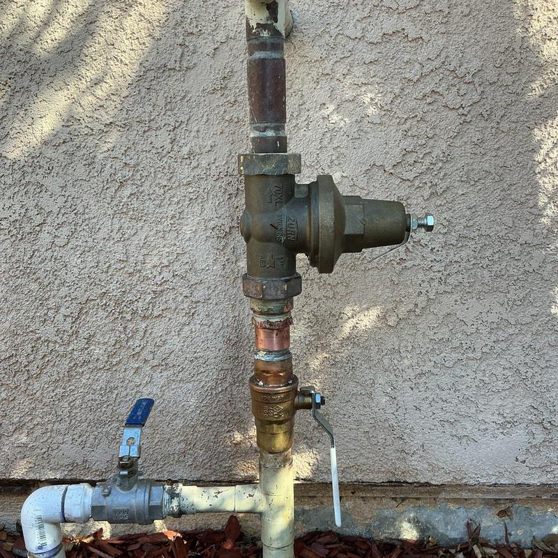 Ball valve and pressure regulator on outdoor pipe