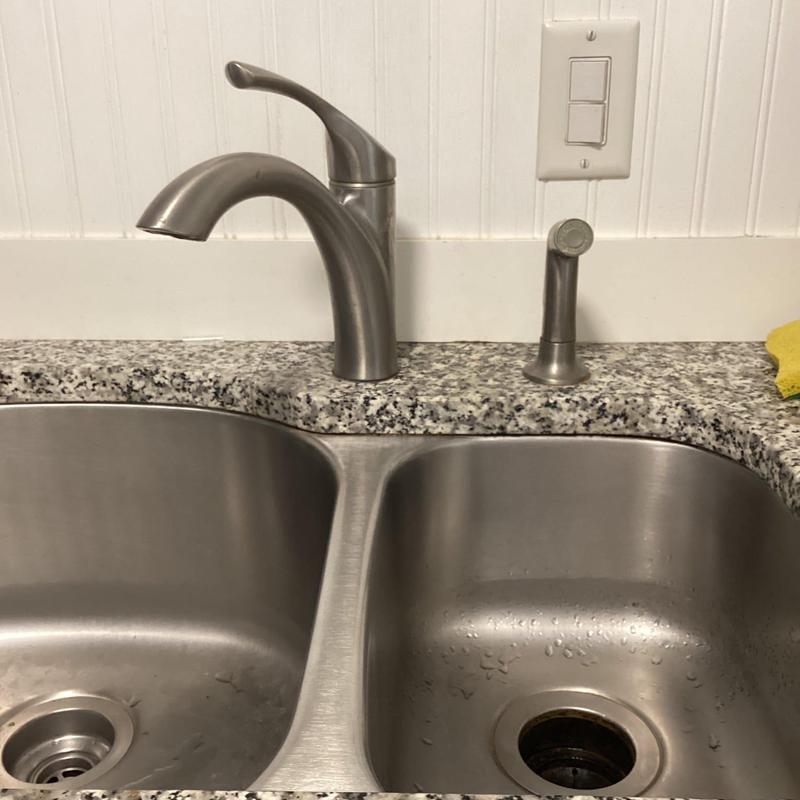 Kitchen sink faucet and sprayer on granite countertop