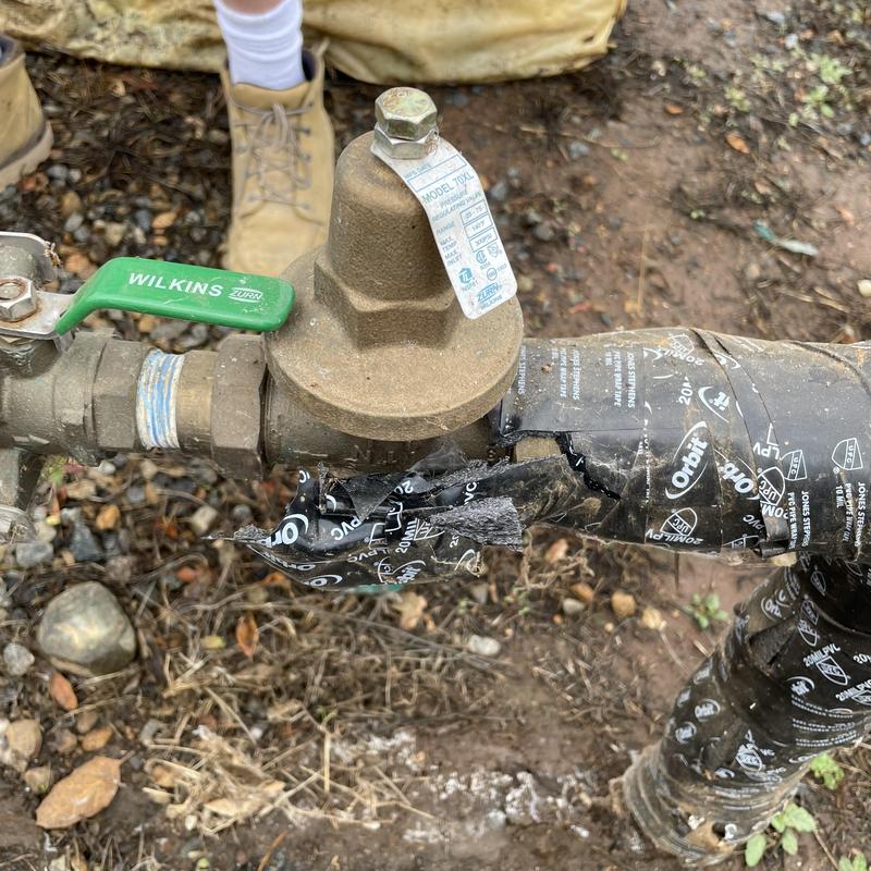 Pressure regulator valve on outdoor water pipe with wrap