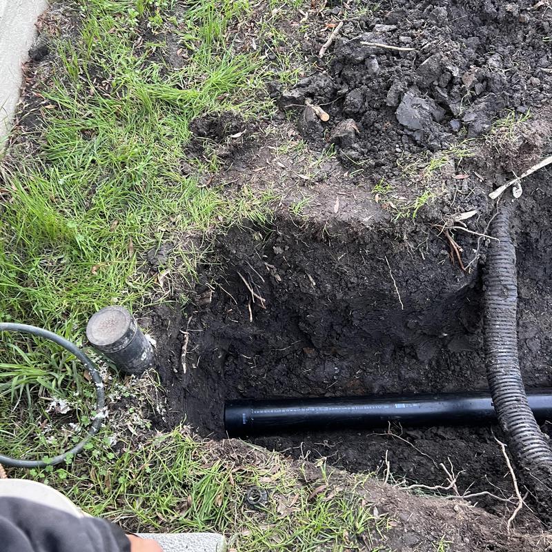 4-inch ABS sewer main pipe installation in trench
