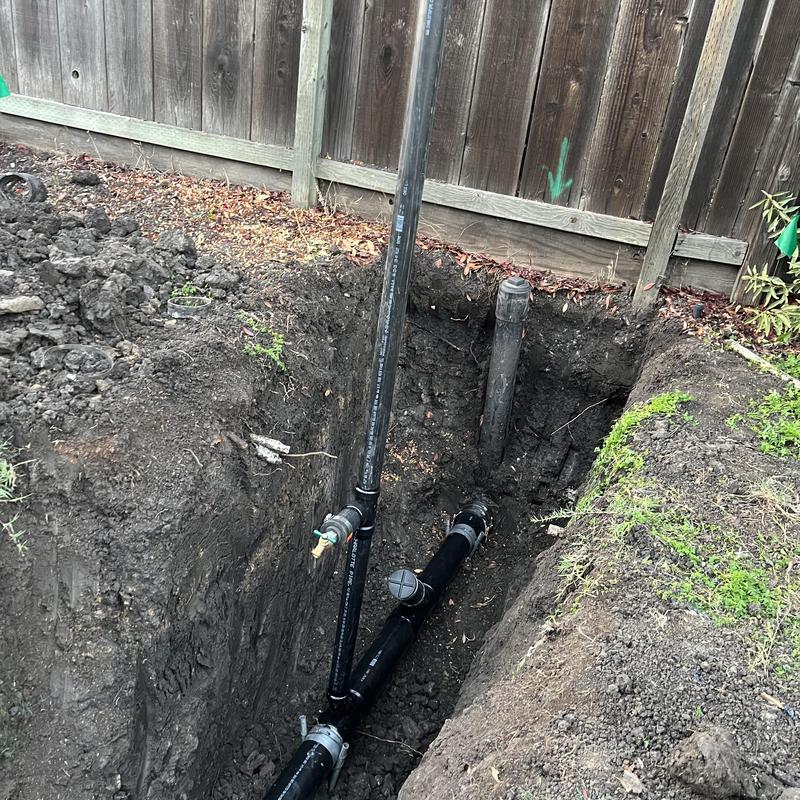 4-inch ABS sewer main installation in backyard trench