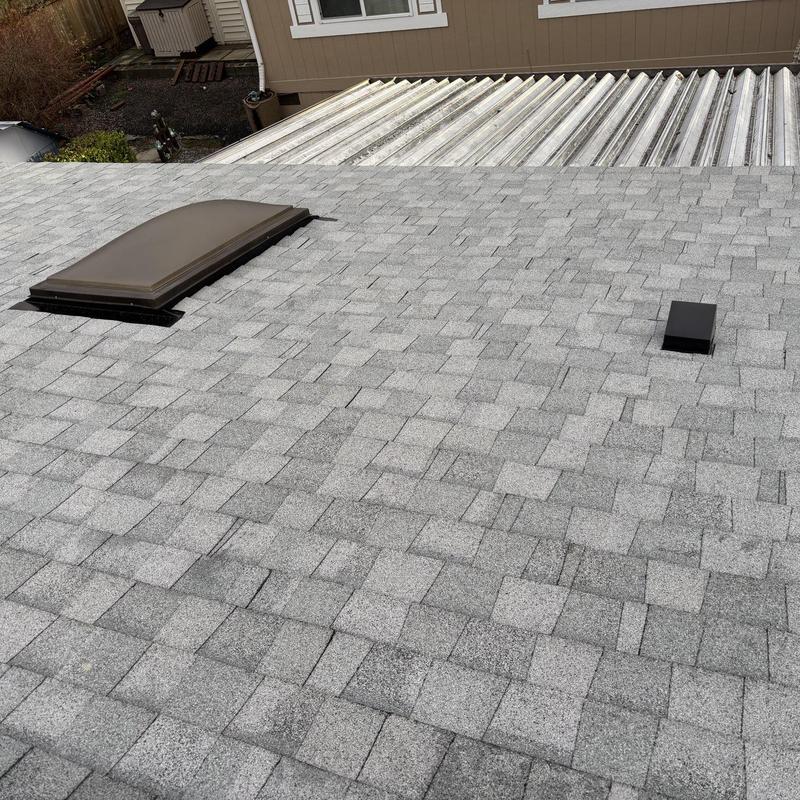 Asphalt shingle roof with skylight and vent pipe