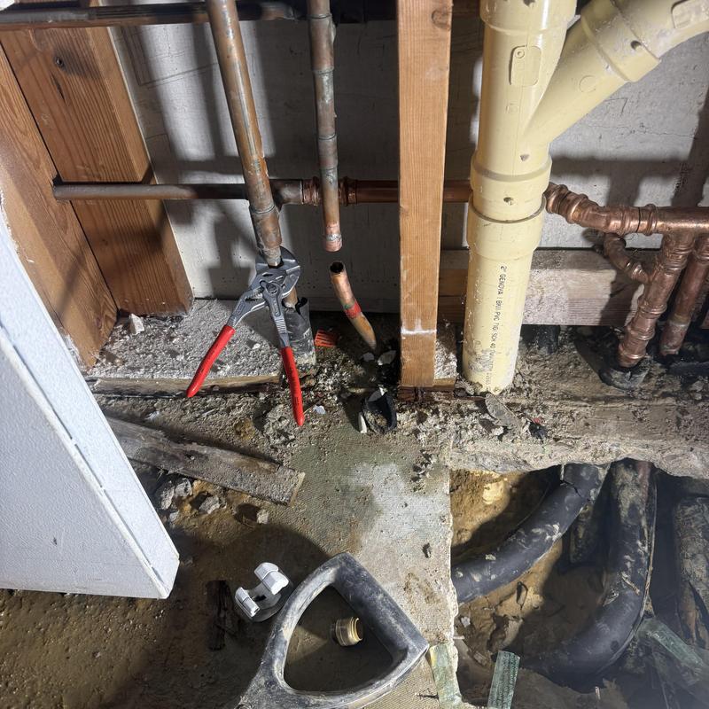 Copper water supply pipes with plumbing tools in foundation wall Copper water supply pipes with plumbing tools in foundation wall