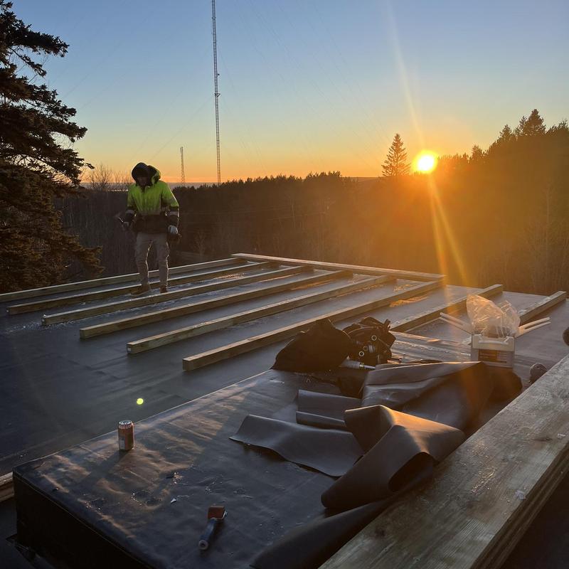 GenFlex EPDM roof with sleeper deck installation at sunset