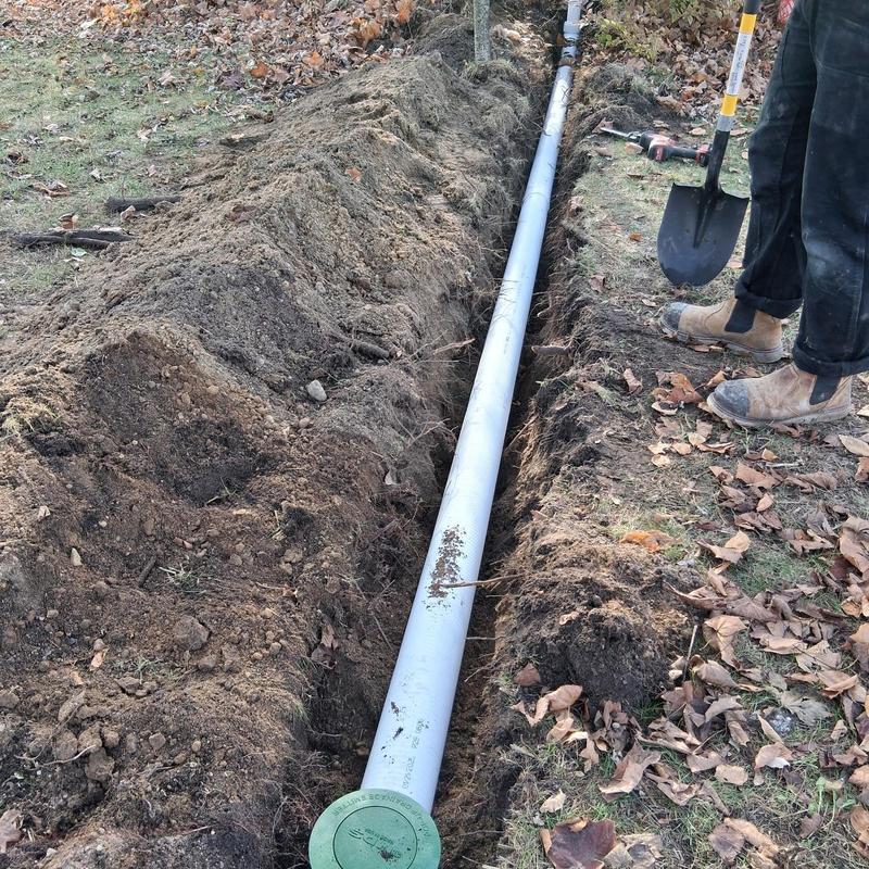 Underground discharge pipe installation in trench