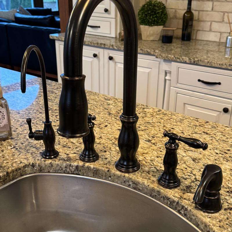 Kitchen faucet with oil-rubbed bronze finish on granite countertop
