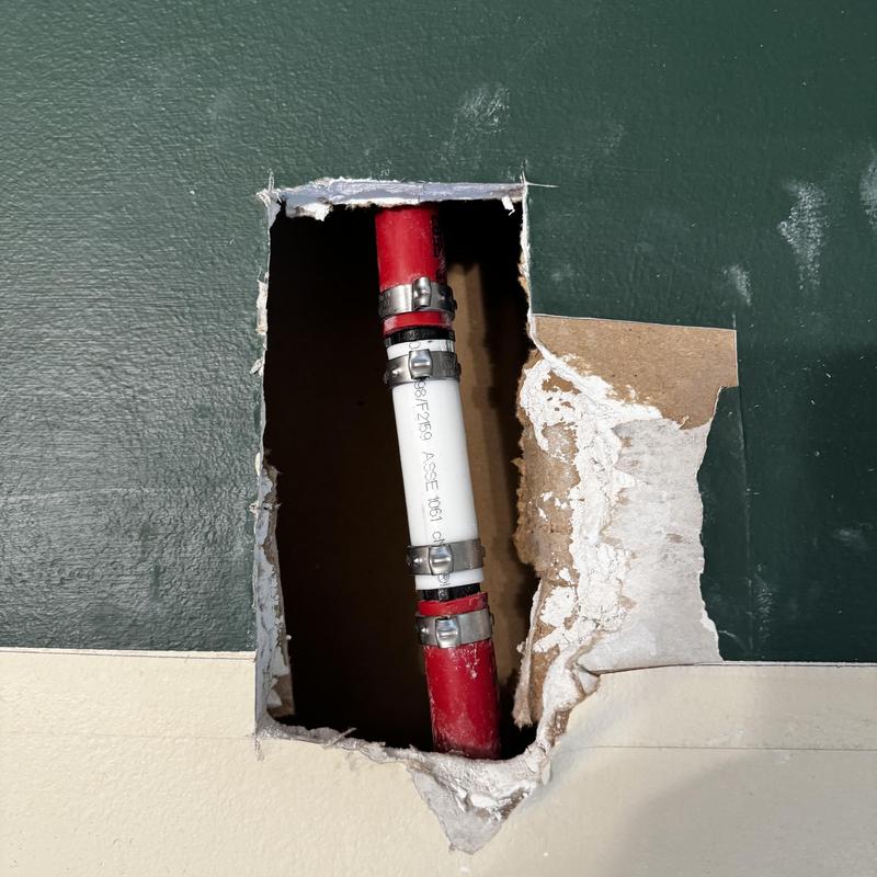 Pex pipe repair with clamps inside wall cavity