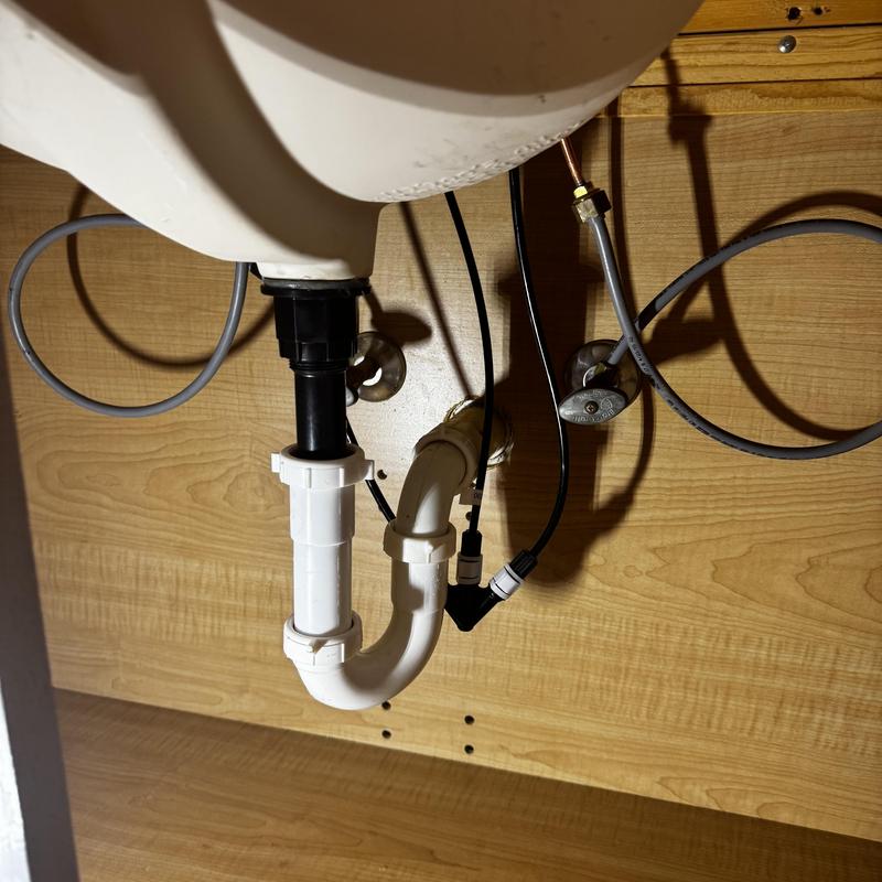 Sink drain pipe and water supply lines under cabinet