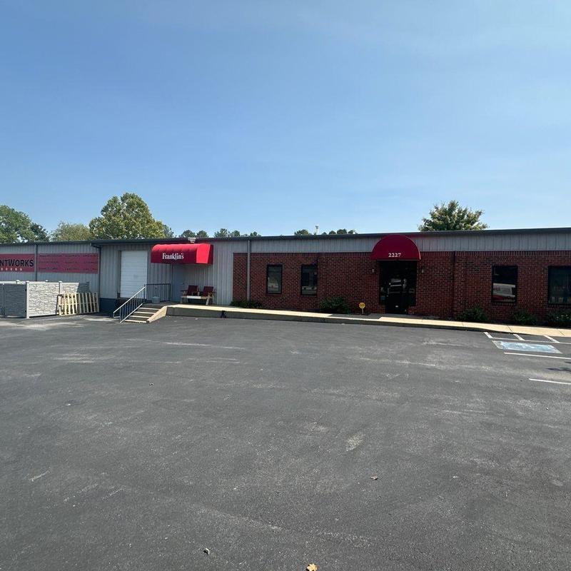 Commercial building exterior with asphalt parking lot
