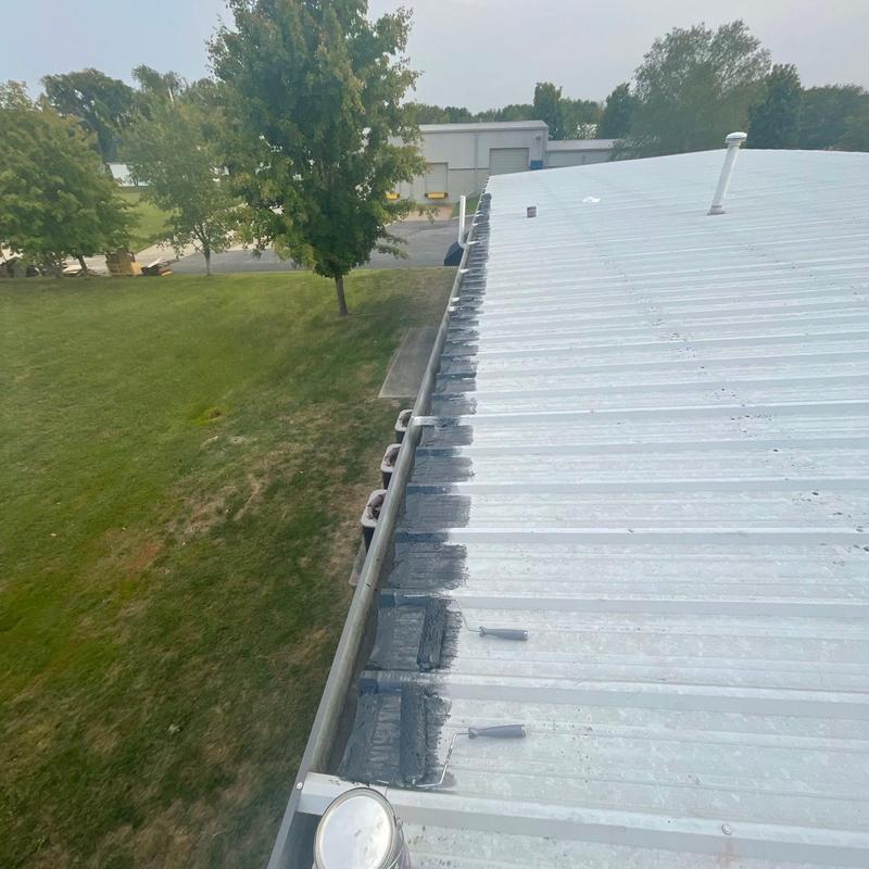 Metal roof edge with black protective coating application