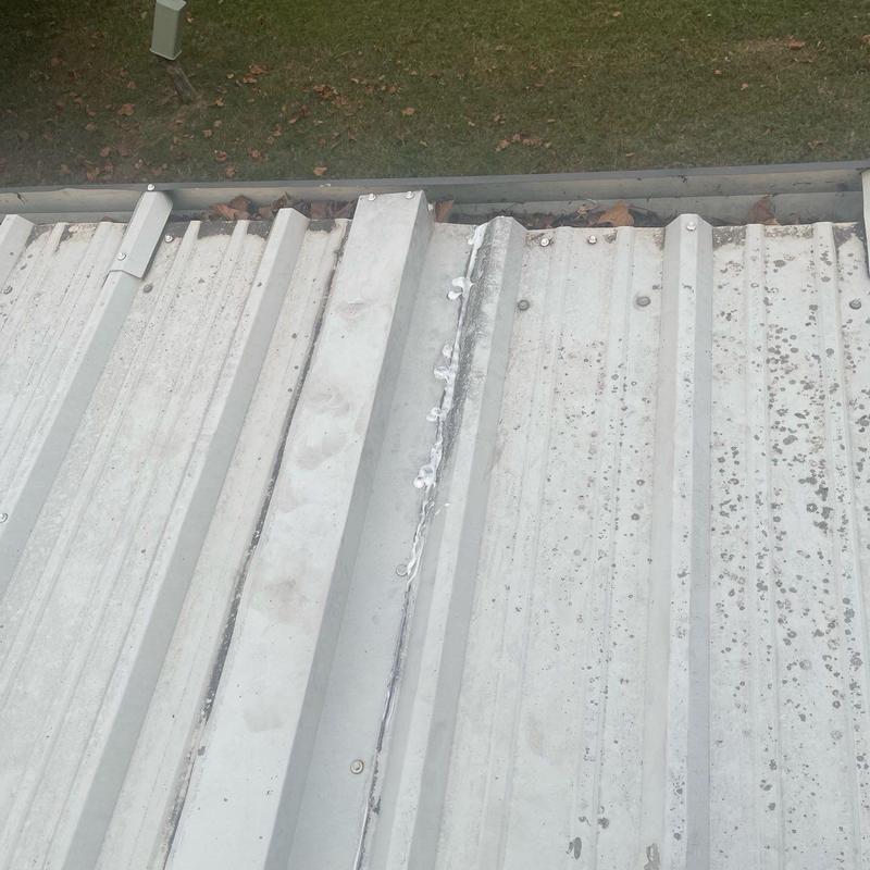Metal roof panels with sealed seams and fasteners
