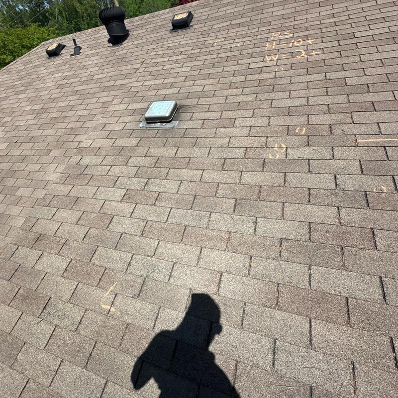 Roof shingles with chalk markings during inspection