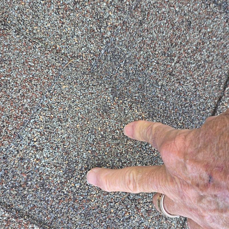 Asphalt roof shingles close-up with finger pointing defect Asphalt roof shingles close-up with finger pointing defect