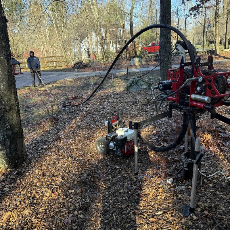 Well pump replacement machine and technician outdoors