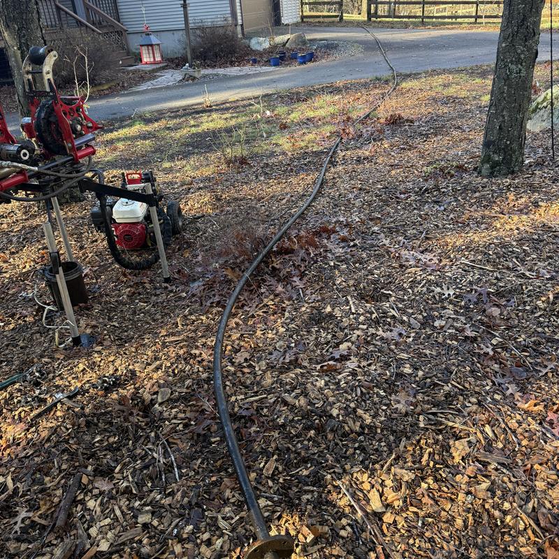 Well pump replacement equipment and pipe on ground