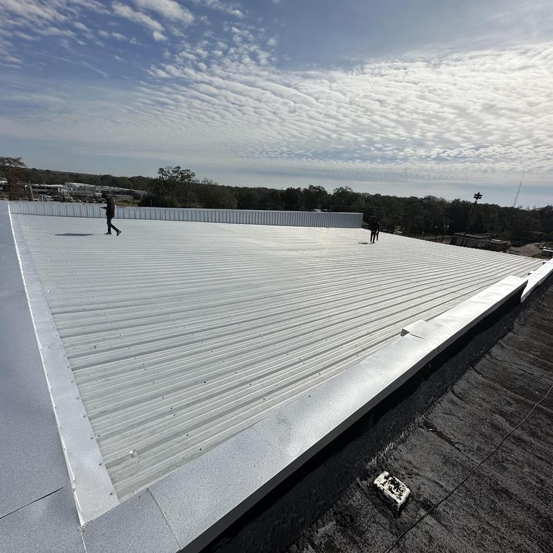 Metal roof with sealed wall panels on low pitch roof Metal roof with sealed wall panels on low pitch roof