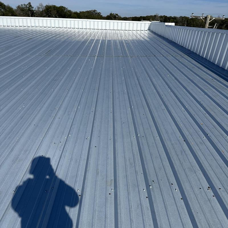 Metal roof panels on low-pitch commercial roof Metal roof panels on low-pitch commercial roof