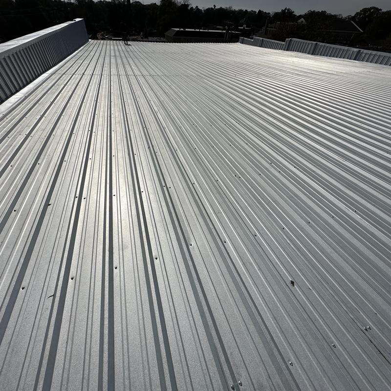 Metal roof panels on low pitch commercial building Metal roof panels on low pitch commercial building