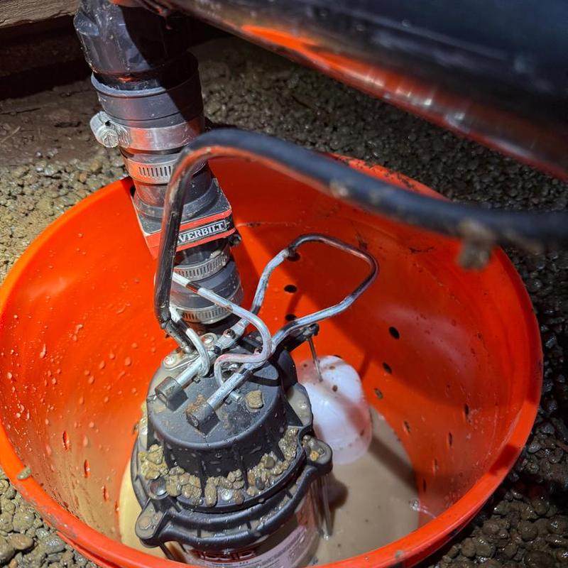 Sump pump in perforated basin with PVC piping