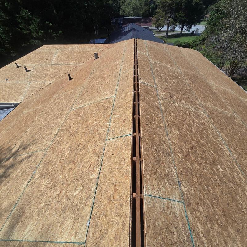 OSB roof sheathing installation on residential roof ridge OSB roof sheathing installation on residential roof ridge