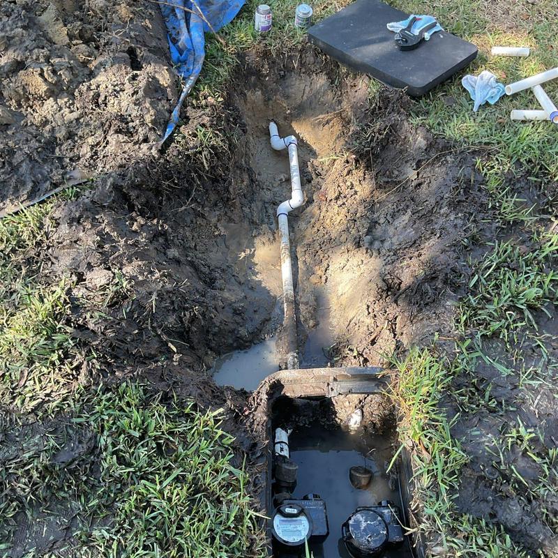 Water main pipe and meter repair in muddy trench