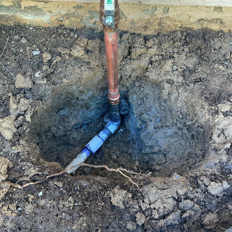 PVC and copper pressure regulator piping repair excavation