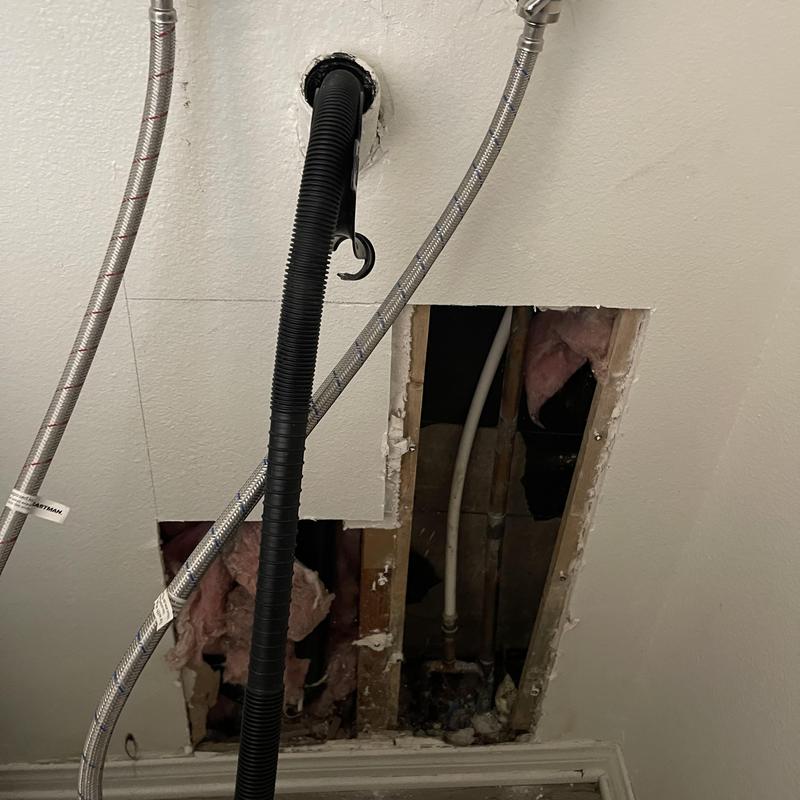 Water line under slab with drywall access cut for reroute