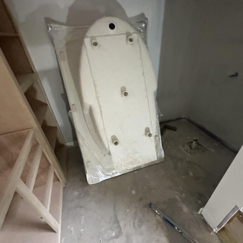 Soaker bathtub shell leaning in unfinished bathroom Soaker bathtub shell leaning in unfinished bathroom