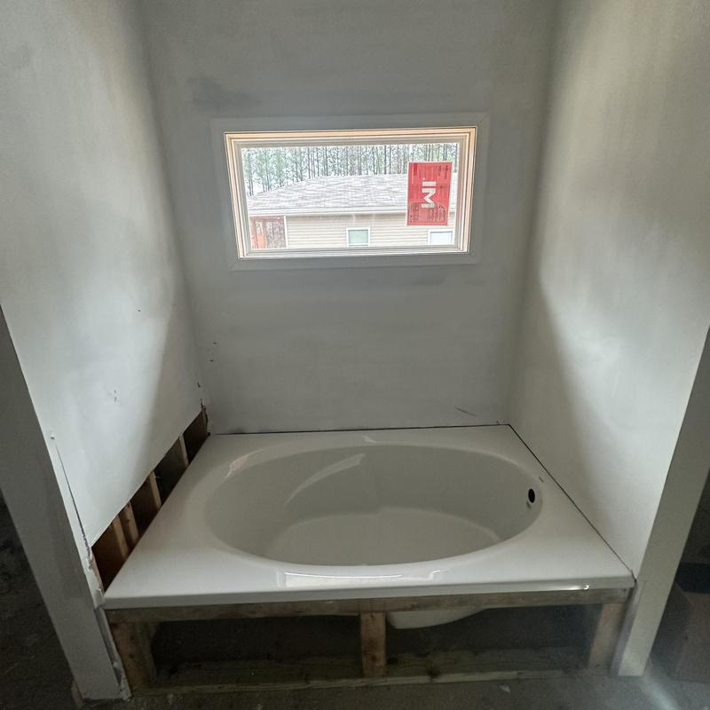 Soaker bathtub installation with window in progress Soaker bathtub installation with window in progress