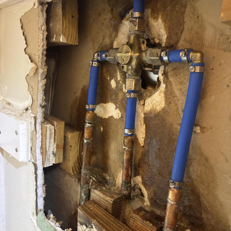 Moen shower valve with blue PEX plumbing lines
