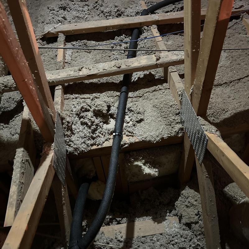 Insulated waterline reroute in attic with wood framing