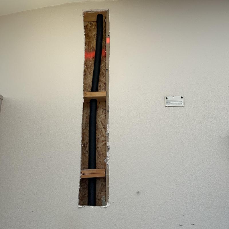 Insulated water pipes inside wall cavity cutout